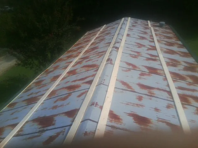Rusted metal roof panels with new wood purlins before replacement — Storm Damage Roof Repair in Dawsonville by Roofing Brothers